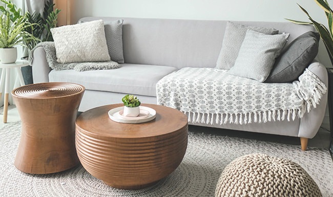a white couch and 2 brown coffee tables